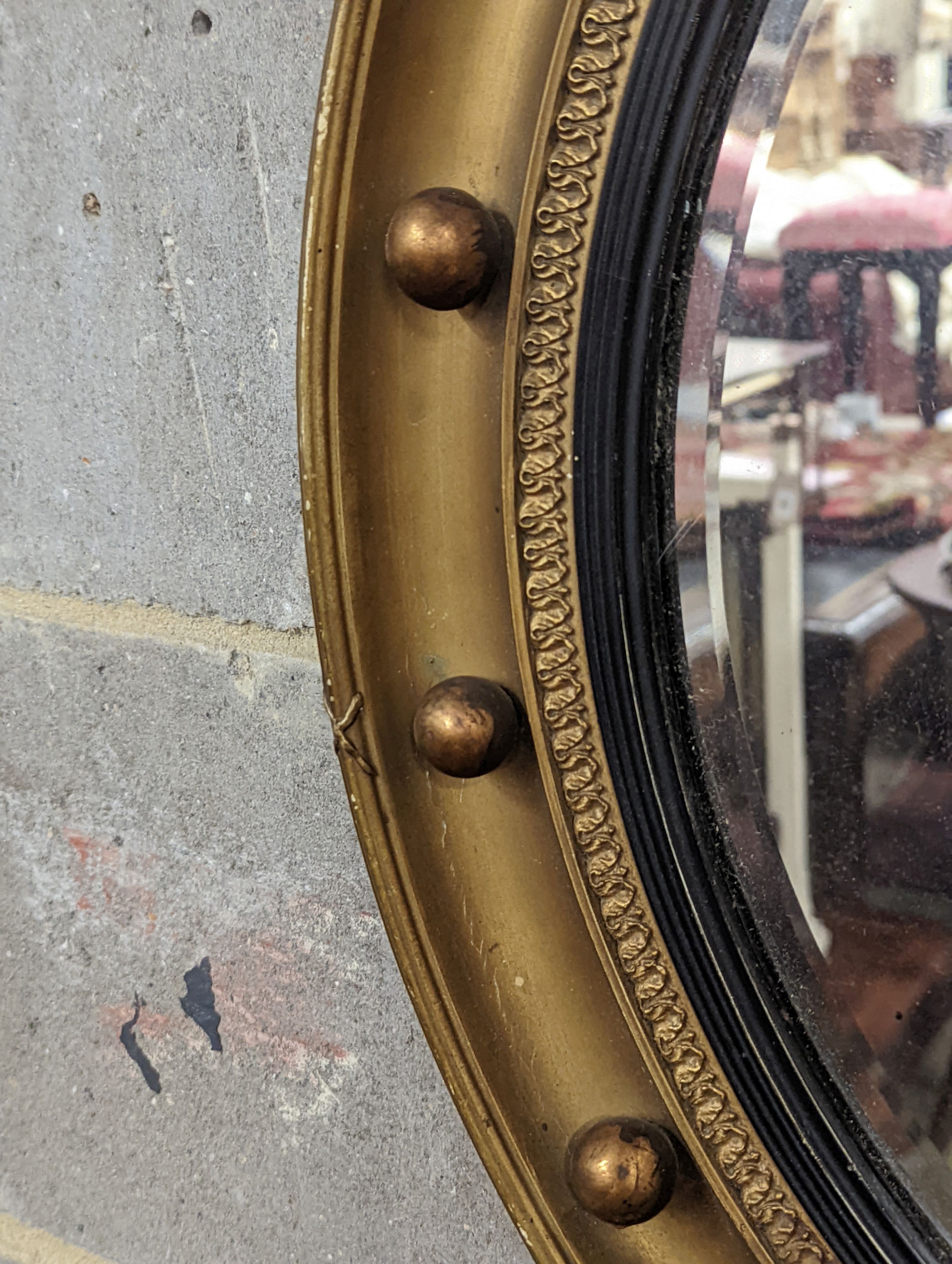 A Regency style circular gilt framed wall mirror, diameter 59cm